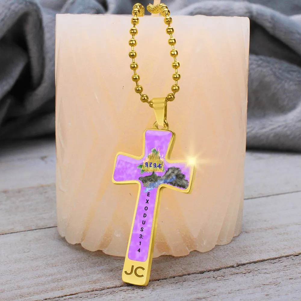A cross necklace resting on a table depicting the burning bush of Ahayah